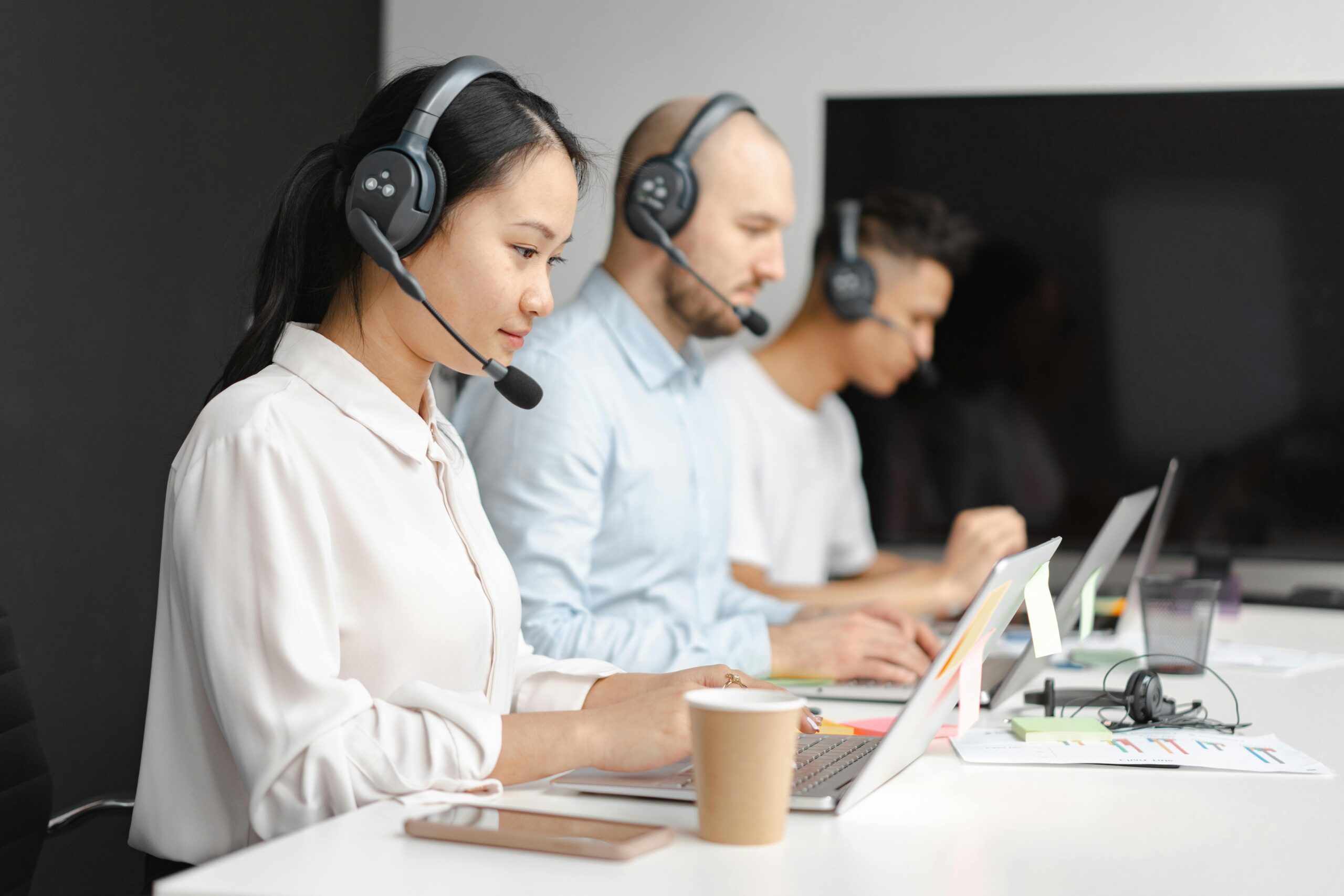 Customer support team at work: focused professionals with headsets, representing tech - driven service for retail ai solutions.