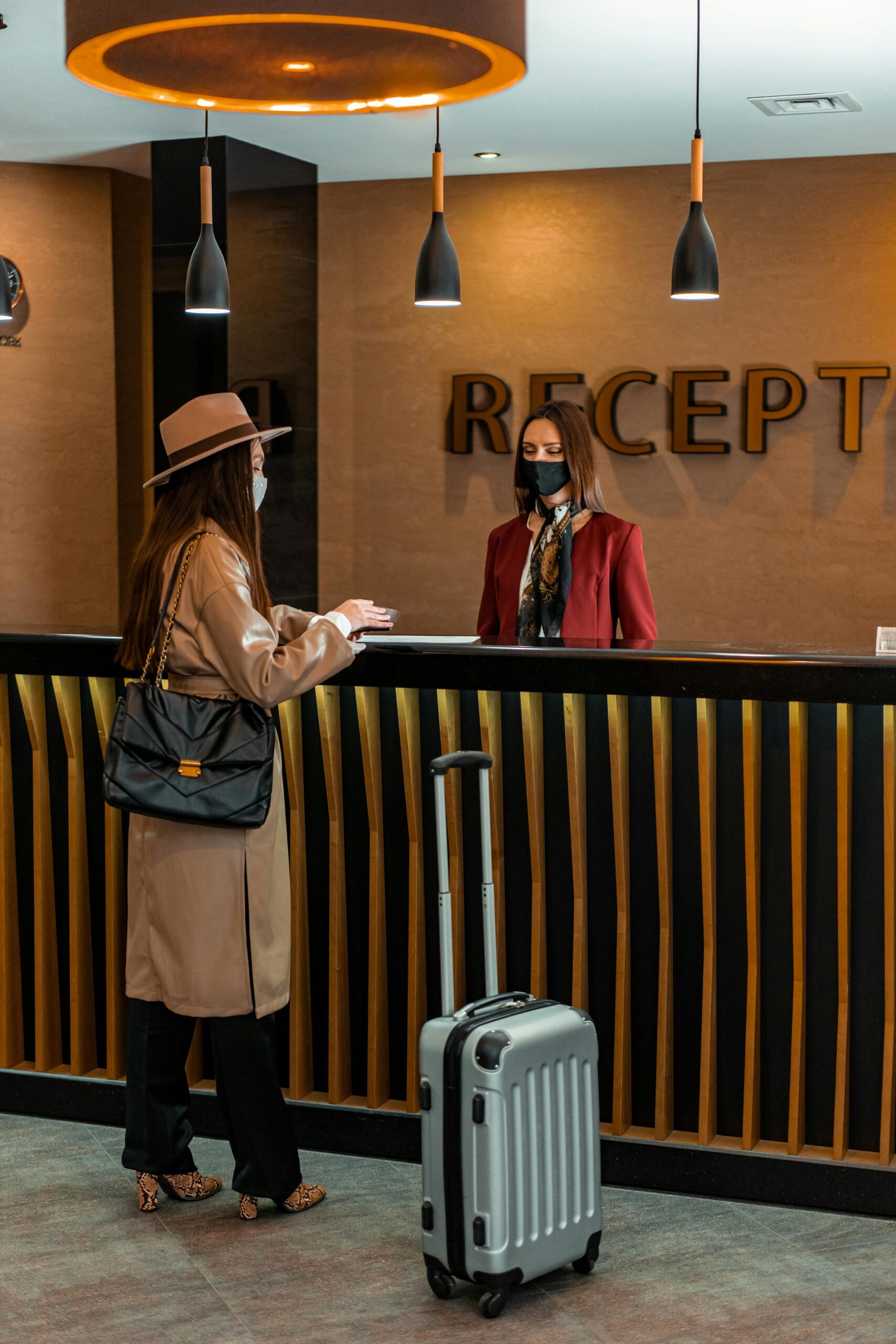 Guest interacting with receptionist at hotel reception, showcasing potential for digital human technology to enhance hotel services through ai-powered guest interactions